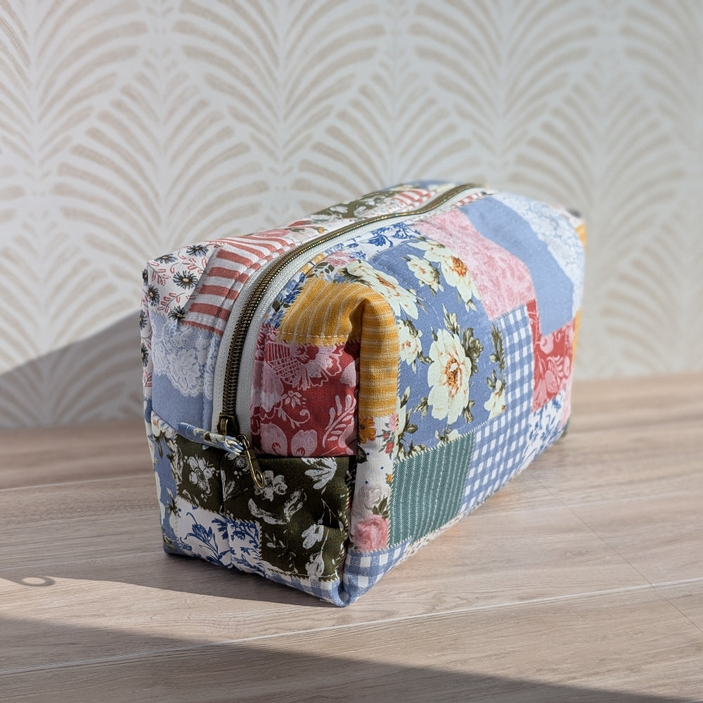 Multicolored fabric pouch with floral patterns on a wooden surface