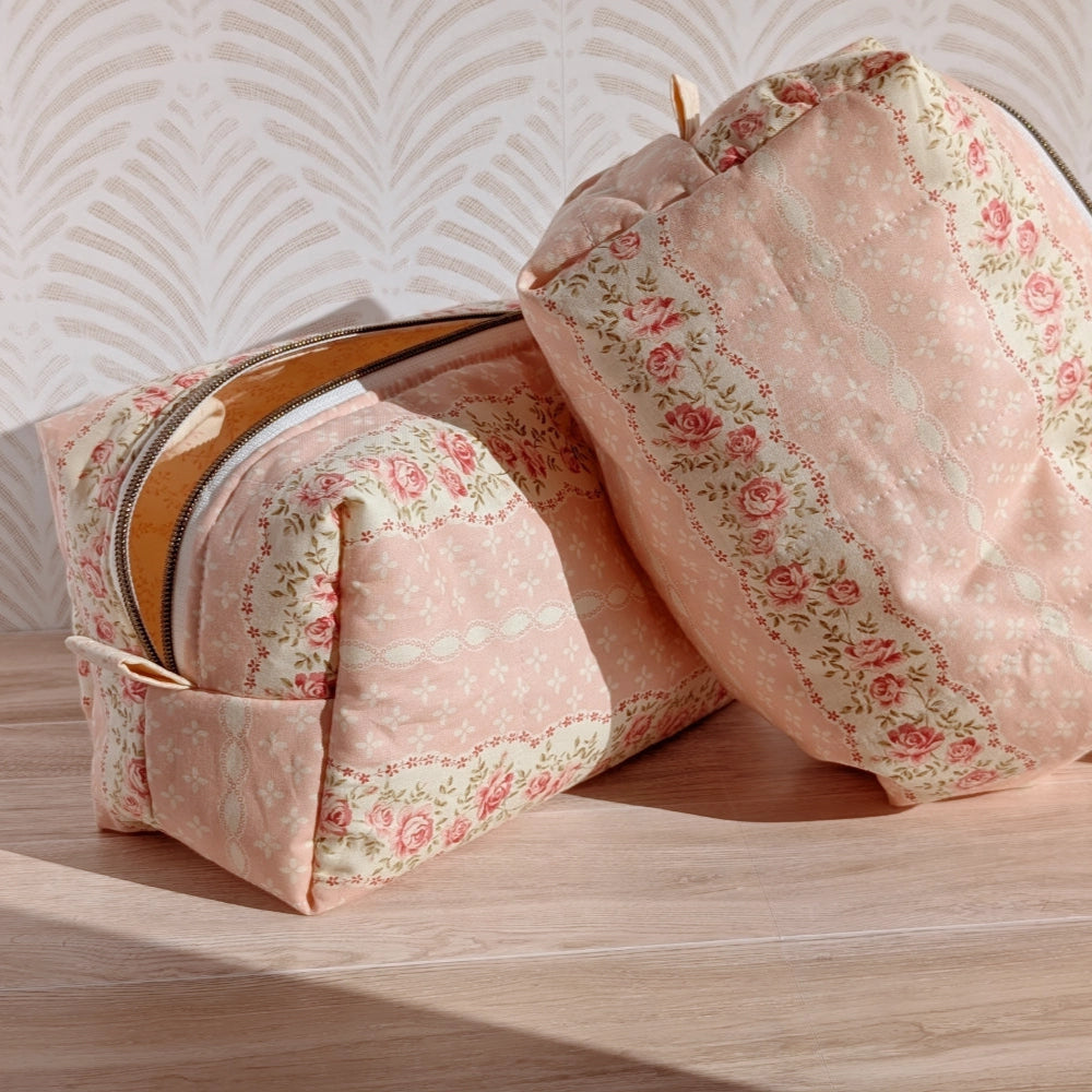 Floral-patterned fabric storage bins on a wooden surface with a light background