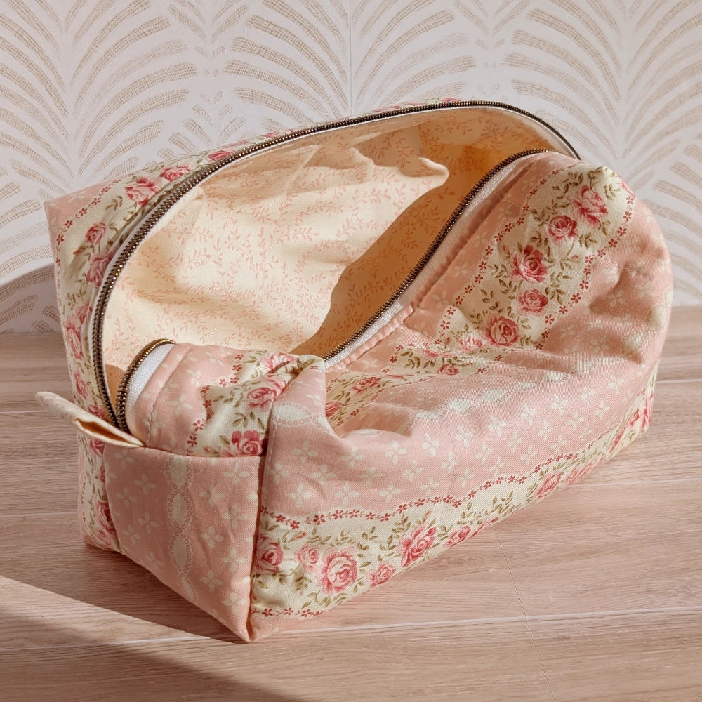 Floral-patterned makeup bag on a wooden surface with a light background