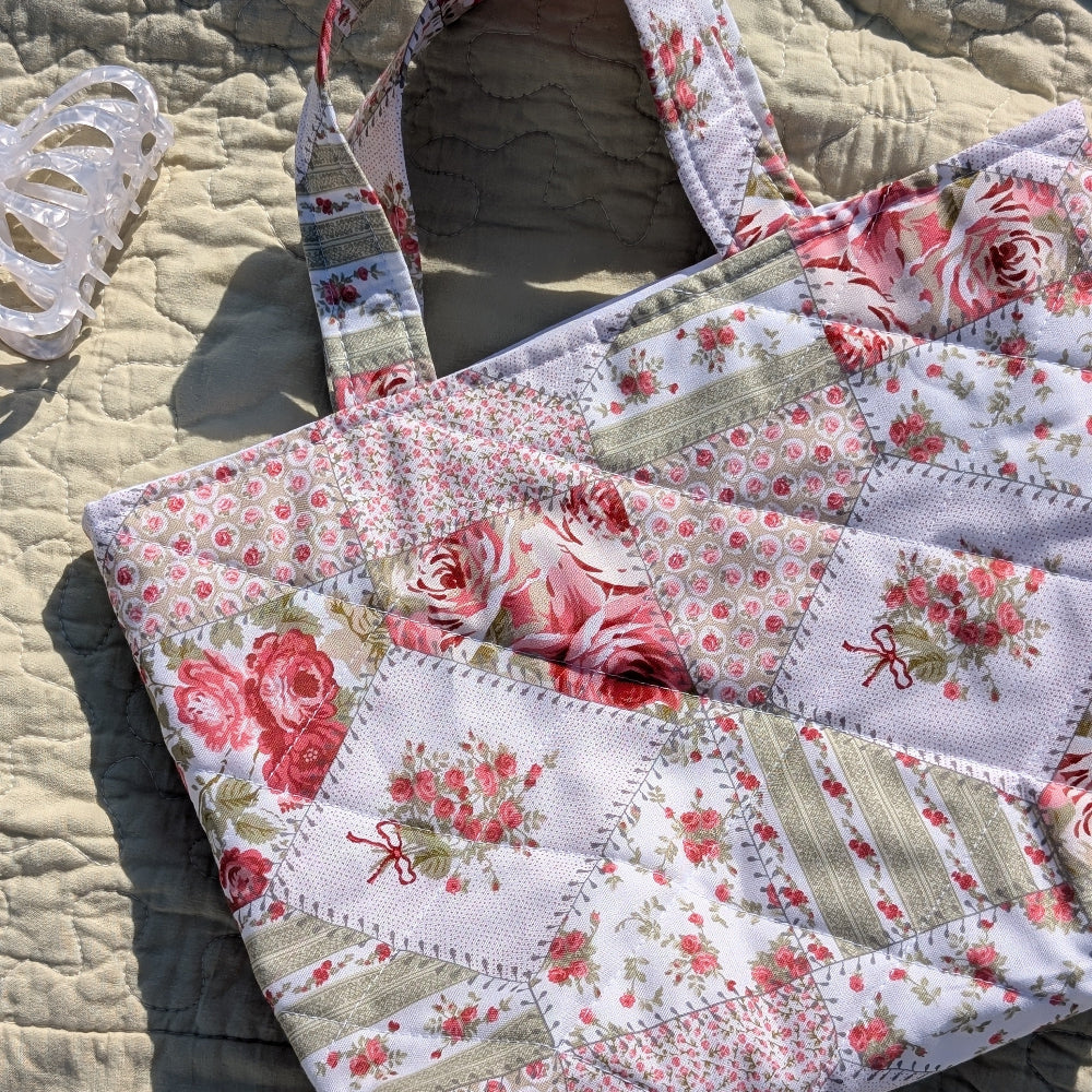 Floral patchwork handbag on a textured surface