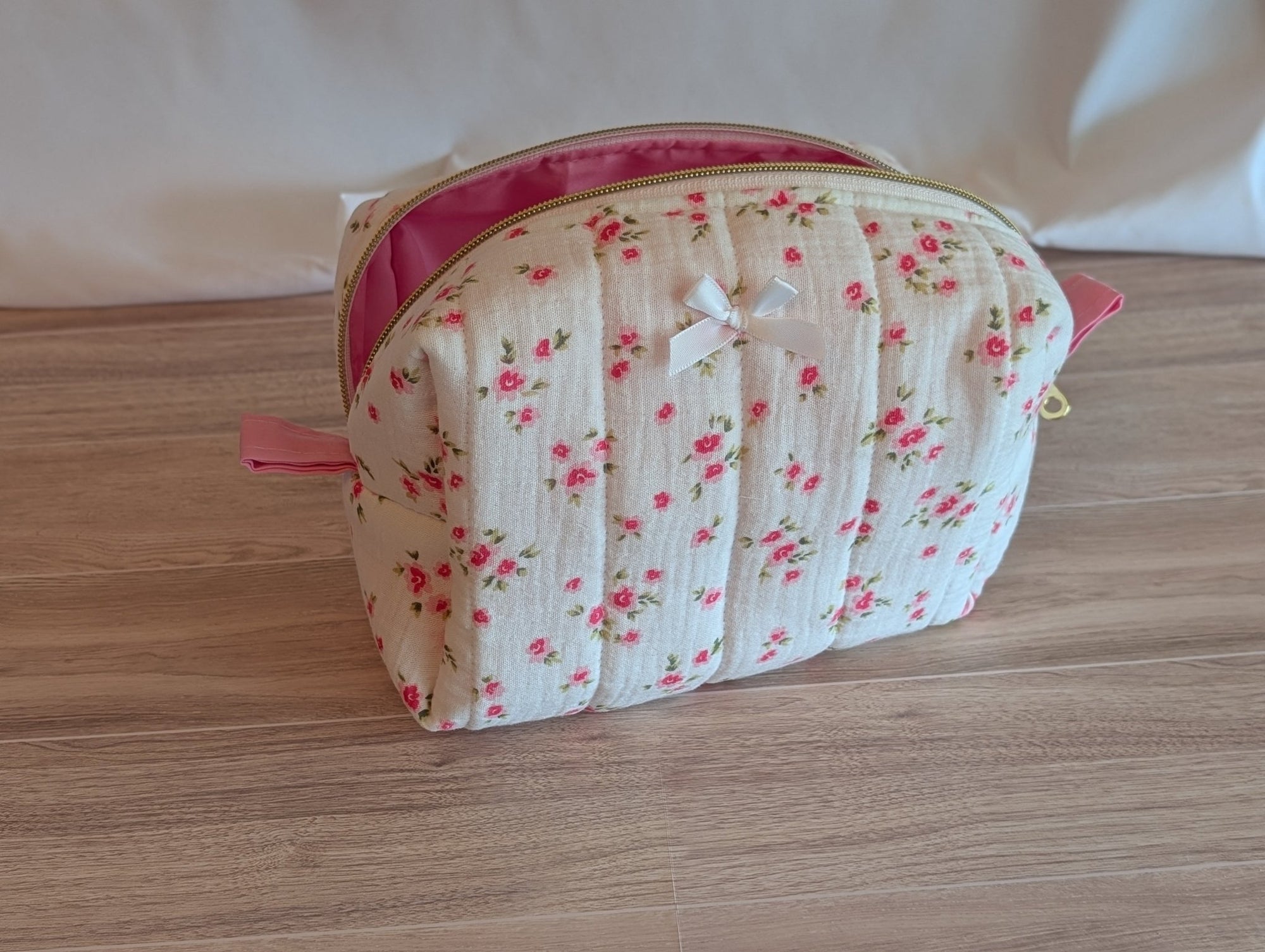 Floral-patterned cosmetic bag on a wooden surface